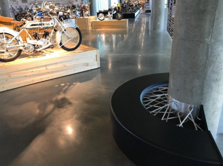 The bench at this motorcycle museum is made to look like a spoked wheel.