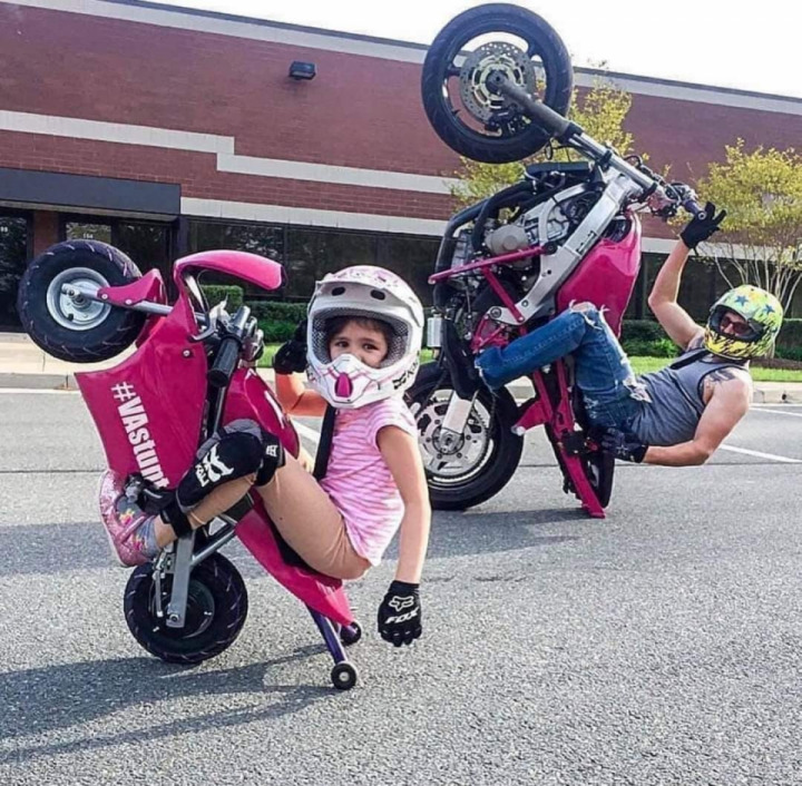 Father and daughter wheelies 
