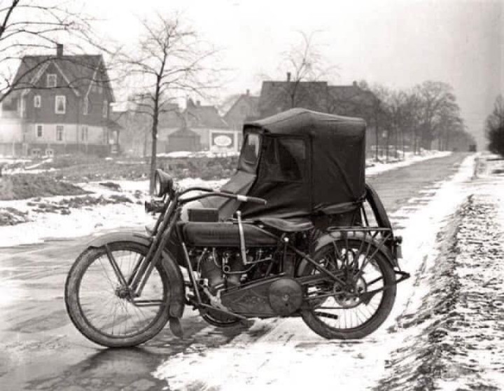 A 1920s Harley Davidson with covered sidecar.