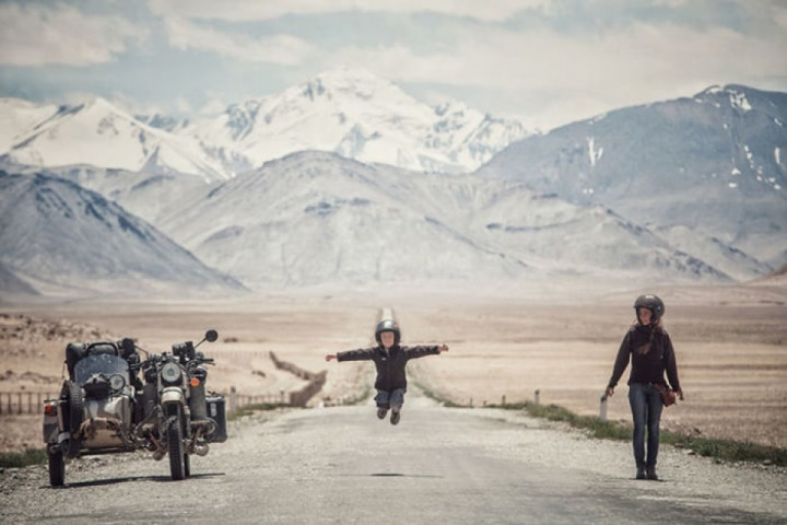On a motorcycle with your family to see the world