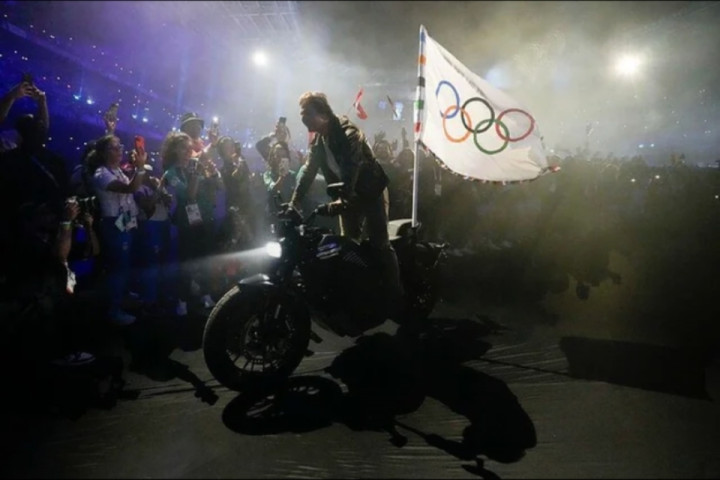 Tom Cruise riding out of the Paris Olympics closing ceremony