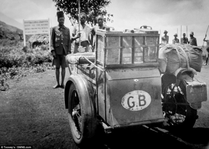 A GB sticker displayed on the back of the motorbike as locals stand in front of it. Toovey explained:& 'There all sorts of different views, there are a really good mixture - not many of the ladies though because they were taking the photos rather than being in them'&