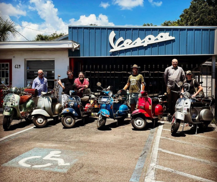 A group of riders from the Vespa Club of America