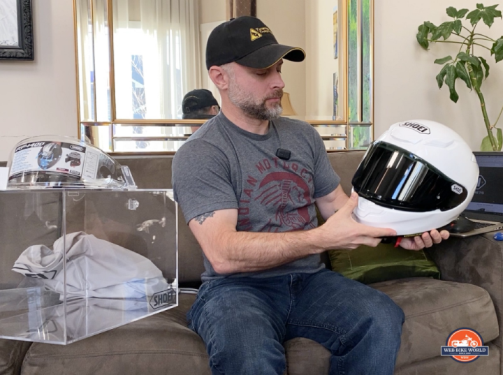 A view of Jimbo holding the RF-1400 helmet from Shoei