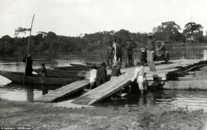 The women can be seen getting their bike off a makeshift raft used to transport it across a waterway during their African voyage. Toovey said: 'It's quite an important crossing of Africa and these slides are a fascinating archive. Its only bits and bobs but think they're really interesting'