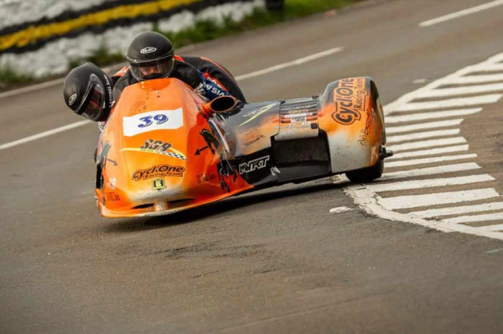 ISLE OF MAN TT: SIDECAR CRASH RESULTS IN TWO LOSSES