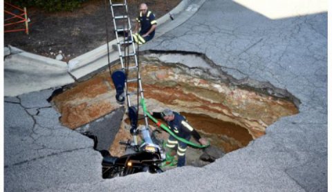 A man as well as his motorcycle, fell in a sinkhole.