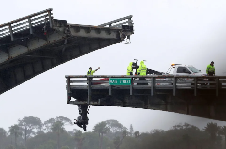 Motorcycle dangling off Main Street bridge in Daytona Beach after rider ran safety arm.