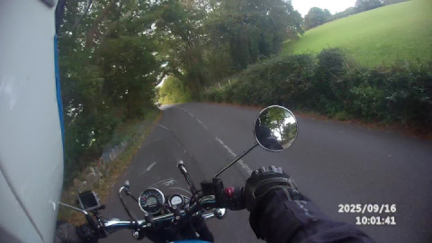 Royal enfield meteor 350 passing a view of Blackpool sands on the A379 coast road.