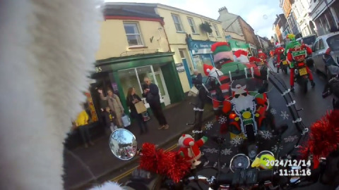 A warm welcome from Tiverton as Santa's on a bike little bridge house pass through the town.